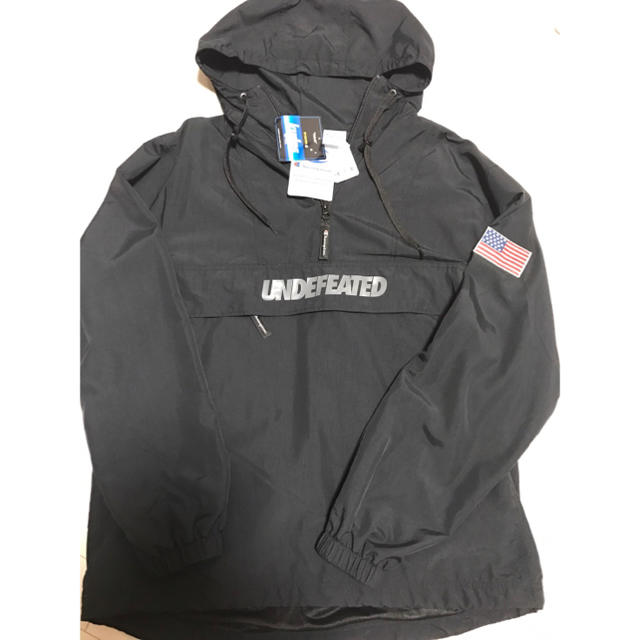 UNDEFEATED(アンディフィーテッド)のUNDEFEATED Champion アノラック ブラック メンズのジャケット/アウター(ナイロンジャケット)の商品写真