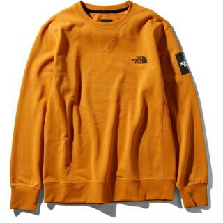 ザノースフェイス(THE NORTH FACE)のノースフェイス スクエアロゴクルー NT11954 L インカゴールド  IG(スウェット)