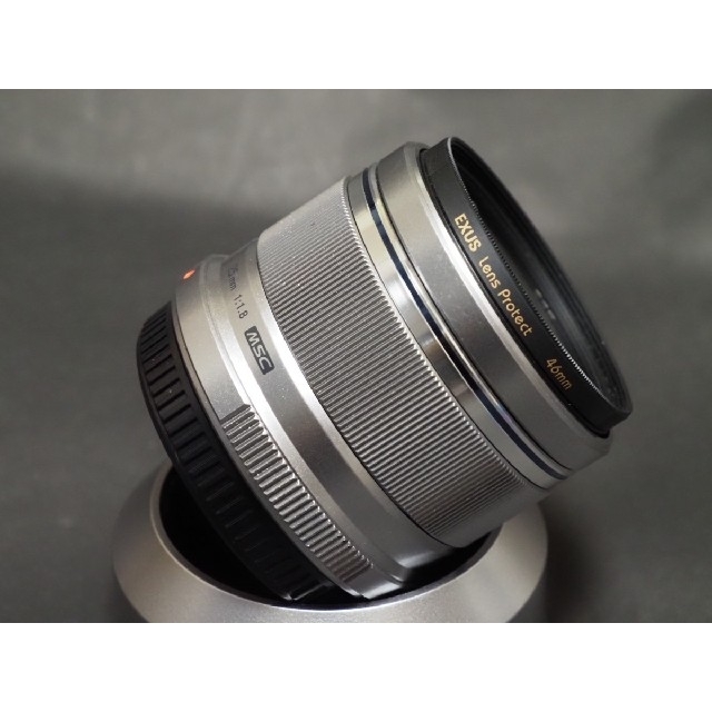 OLYMPUS(オリンパス)のオリンパス  単焦点レンズM.Zuiko 25mmF1.8プロテクタ、フード付 スマホ/家電/カメラのカメラ(レンズ(単焦点))の商品写真