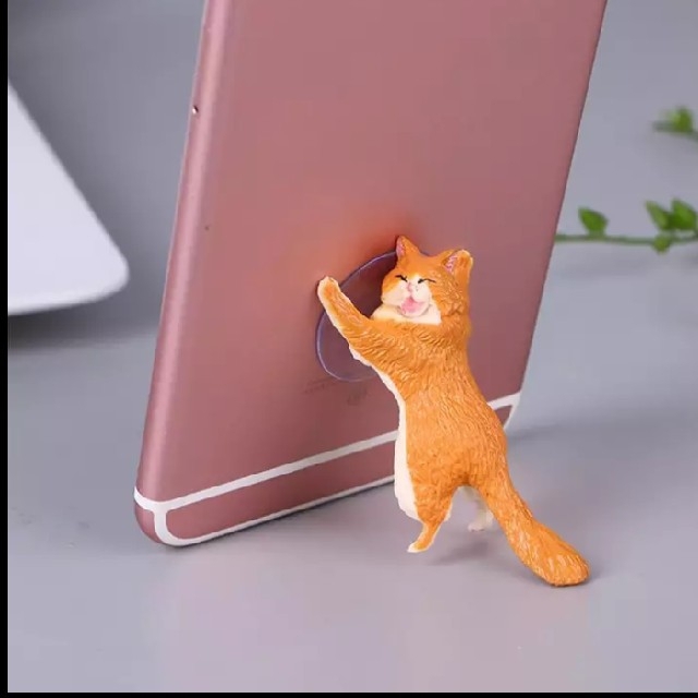 猫が支える　スマホスタンド　単品　オレンジ スマホ/家電/カメラのスマホアクセサリー(その他)の商品写真