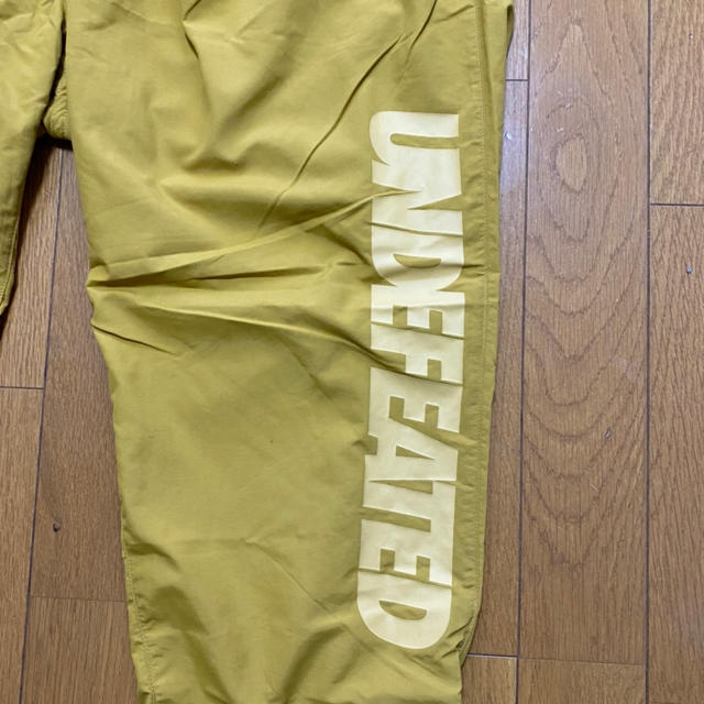 UNDEFEATED(アンディフィーテッド)のundefeated チャンピオンコラボ ナイロンパンツ メンズのパンツ(その他)の商品写真