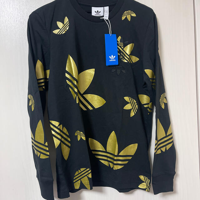 adidas(アディダス)の新品　adidas originals 黒　金ロゴ 総柄 ロンT メンズのトップス(Tシャツ/カットソー(七分/長袖))の商品写真