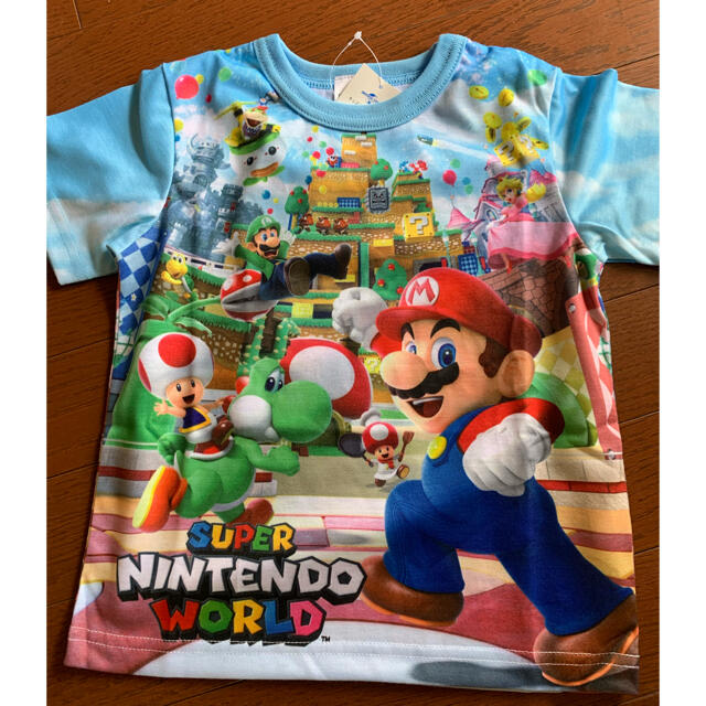 USJ(ユニバーサルスタジオジャパン)のUSJ マリオ　Tシャツ　キッズ　スーパーニンテンドーワールド☆新品 エンタメ/ホビーのおもちゃ/ぬいぐるみ(キャラクターグッズ)の商品写真