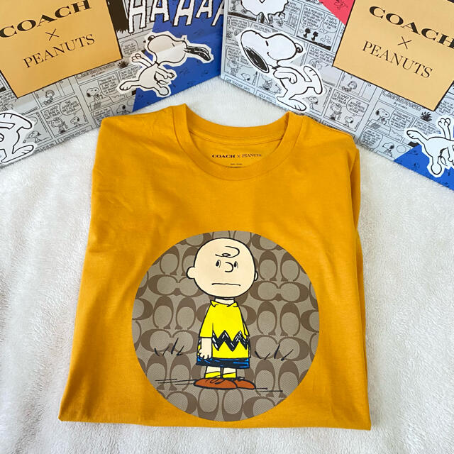 COACH(コーチ)のコーチ　スヌーピー　ピーナッツ　チャーリーブラウン　Tシャツ　オレンジ　2021 メンズのトップス(Tシャツ/カットソー(半袖/袖なし))の商品写真