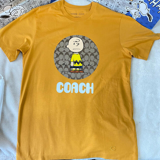 COACH(コーチ)のコーチ　スヌーピー　ピーナッツ　チャーリーブラウン　Tシャツ　オレンジ　2021 メンズのトップス(Tシャツ/カットソー(半袖/袖なし))の商品写真