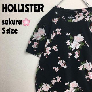 ホリスター(Hollister)のホリスター　HOLLISTER　桜柄　Tシャツ　半袖　総柄　黒／ピンク　Ｓ(Tシャツ/カットソー(半袖/袖なし))