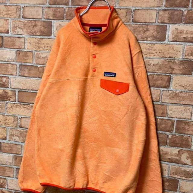 patagonia(パタゴニア)のパタゴニア　フリースジャケット　ハーフボタンオレンジ　アウトドア　古着女子　M. レディースのトップス(その他)の商品写真