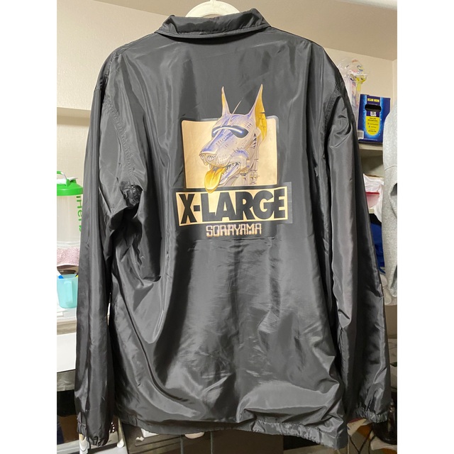 XLARGE(エクストララージ)の「XLARGE×空山基 コーチジャケットブラック｣ メンズのジャケット/アウター(ナイロンジャケット)の商品写真