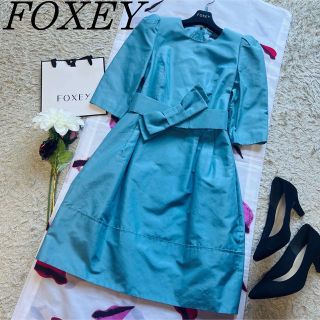 フォクシー(FOXEY)の【良品】FOXEY 膝丈ワンピース ベルト付き リボン ライトブルー 七分袖38(ひざ丈ワンピース)