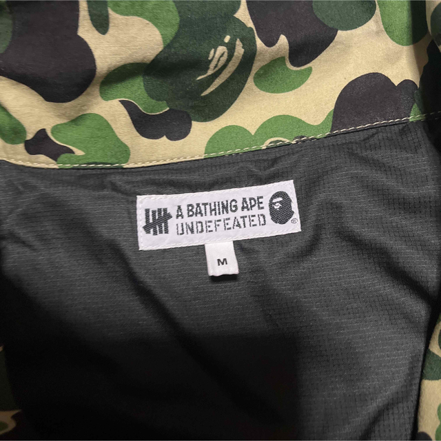 A BATHING APE(アベイシングエイプ)のAPE BAPE KAWS UNDEFEATED M-65 ジャケット　CAMO メンズのジャケット/アウター(ミリタリージャケット)の商品写真