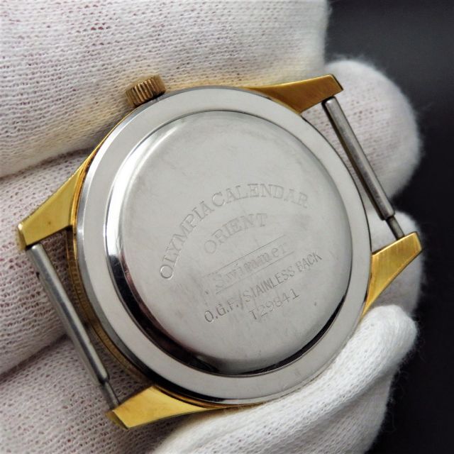 ORIENT(オリエント)のOLYMPIA CALENDAR SWIMMER 手巻き腕時計 変わり文字盤 メンズの時計(腕時計(アナログ))の商品写真