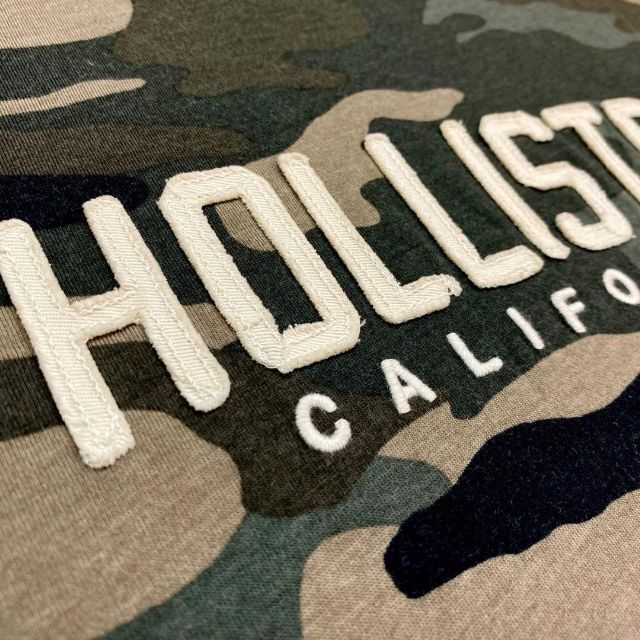 Hollister(ホリスター)の新品【メンズM】★ホリスター★刺しゅう＆ワッペンロゴ長袖Tシャツ/迷彩 メンズのトップス(Tシャツ/カットソー(七分/長袖))の商品写真