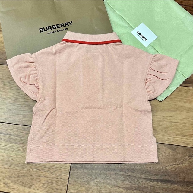 BURBERRY(バーバリー)のアイコンストライプ　ピンク　フリル　ポロシャツ　ブラウス　Tシャツ　半袖 キッズ/ベビー/マタニティのベビー服(~85cm)(Ｔシャツ)の商品写真