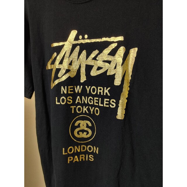 STUSSY(ステューシー)のSTUSSY＊Tシャツ・半袖・サイズＬ＊両面プリントロゴ入り・ブラック・ゴールド レディースのトップス(Tシャツ(半袖/袖なし))の商品写真