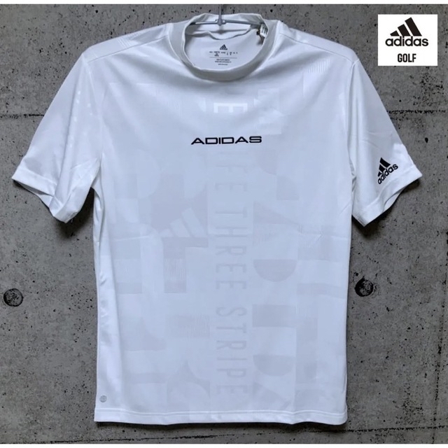 adidas(アディダス)のアディダスゴルフ【L】エンボスプリント 半袖モックネックシャツ（白） スポーツ/アウトドアのゴルフ(ウエア)の商品写真