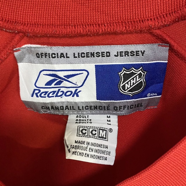 Reebok(リーボック)のリーボック×NHL カルガリーフレームス　ホッケーシャツ　ビッグロゴ メンズのトップス(Tシャツ/カットソー(七分/長袖))の商品写真