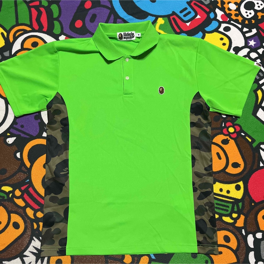 A BATHING APE(アベイシングエイプ)のAPE BAPE  KAWS 1st CAMO 迷彩　ポロシャツ　tシャツ　M メンズのトップス(ポロシャツ)の商品写真