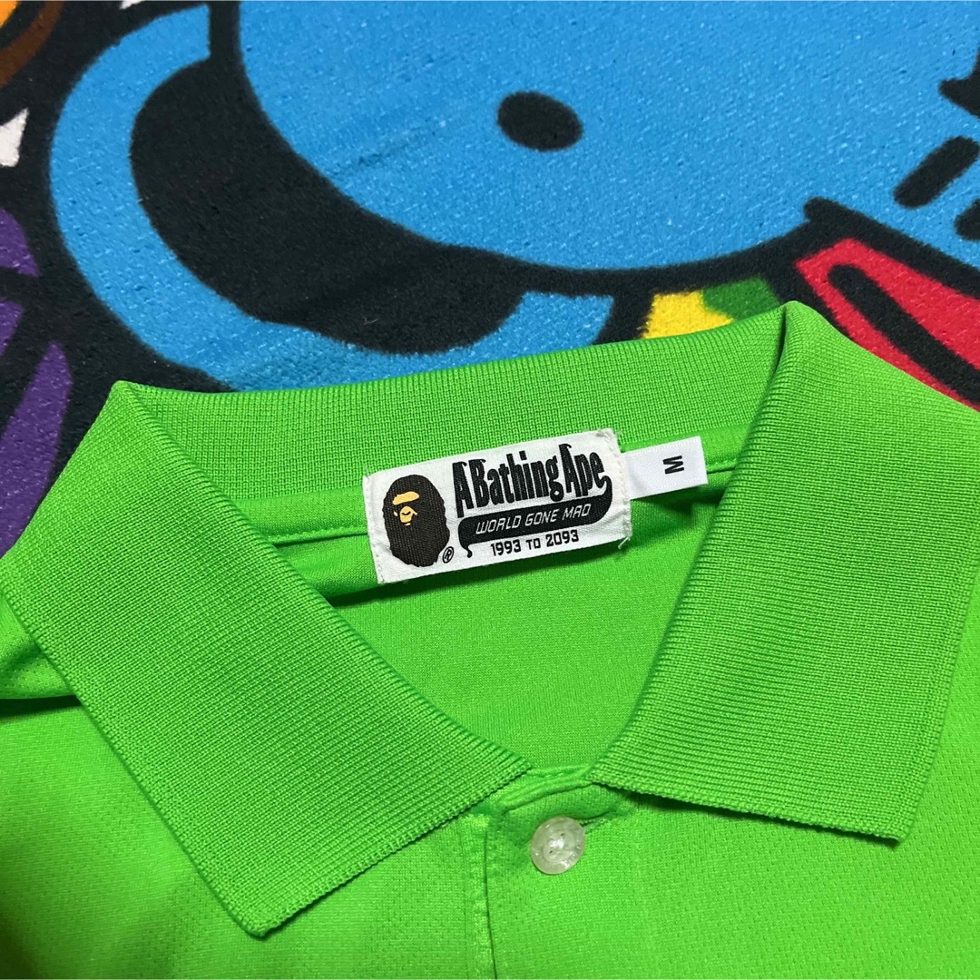 A BATHING APE(アベイシングエイプ)のAPE BAPE  KAWS 1st CAMO 迷彩　ポロシャツ　tシャツ　M メンズのトップス(ポロシャツ)の商品写真