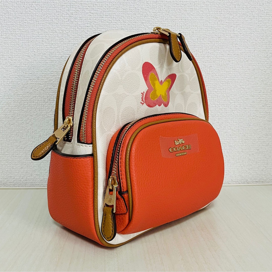 新品 COACH コーチ リュック 蝶々 オレンジ サーモン ピンク