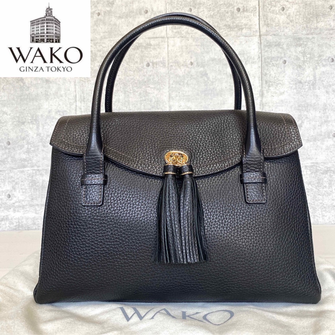 未使用級】WAKO 銀座和光 シボ革 タッセル 黒 ゴールド金具 ハンドバッグ-