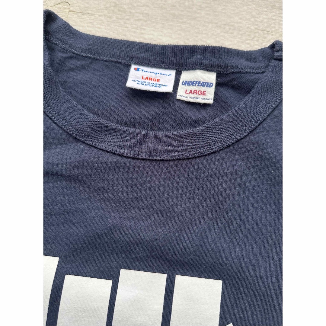 UNDEFEATED(アンディフィーテッド)のUNDEFEATED CHAMPION コラボ Tシャツ L メンズのトップス(Tシャツ/カットソー(半袖/袖なし))の商品写真