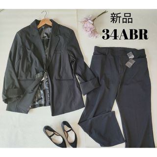 新品 パンツスーツ ストレッチ素材 34ABR 6Lの通販|ラクマ