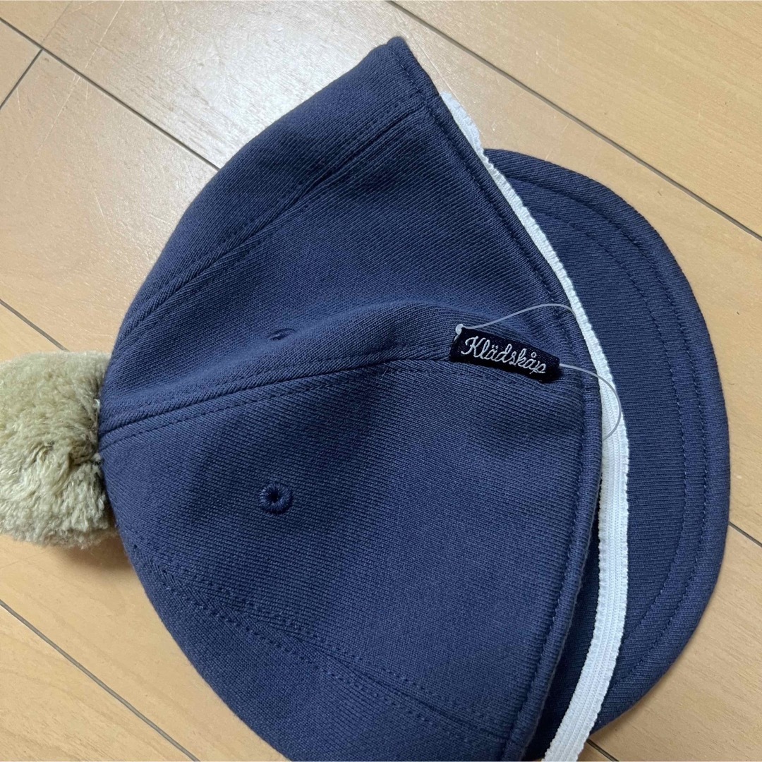 kladskap(クレードスコープ)の【新品】kladskapクレードスコープライオン刺繍ポンポンキャップ46〜48 キッズ/ベビー/マタニティのこども用ファッション小物(帽子)の商品写真