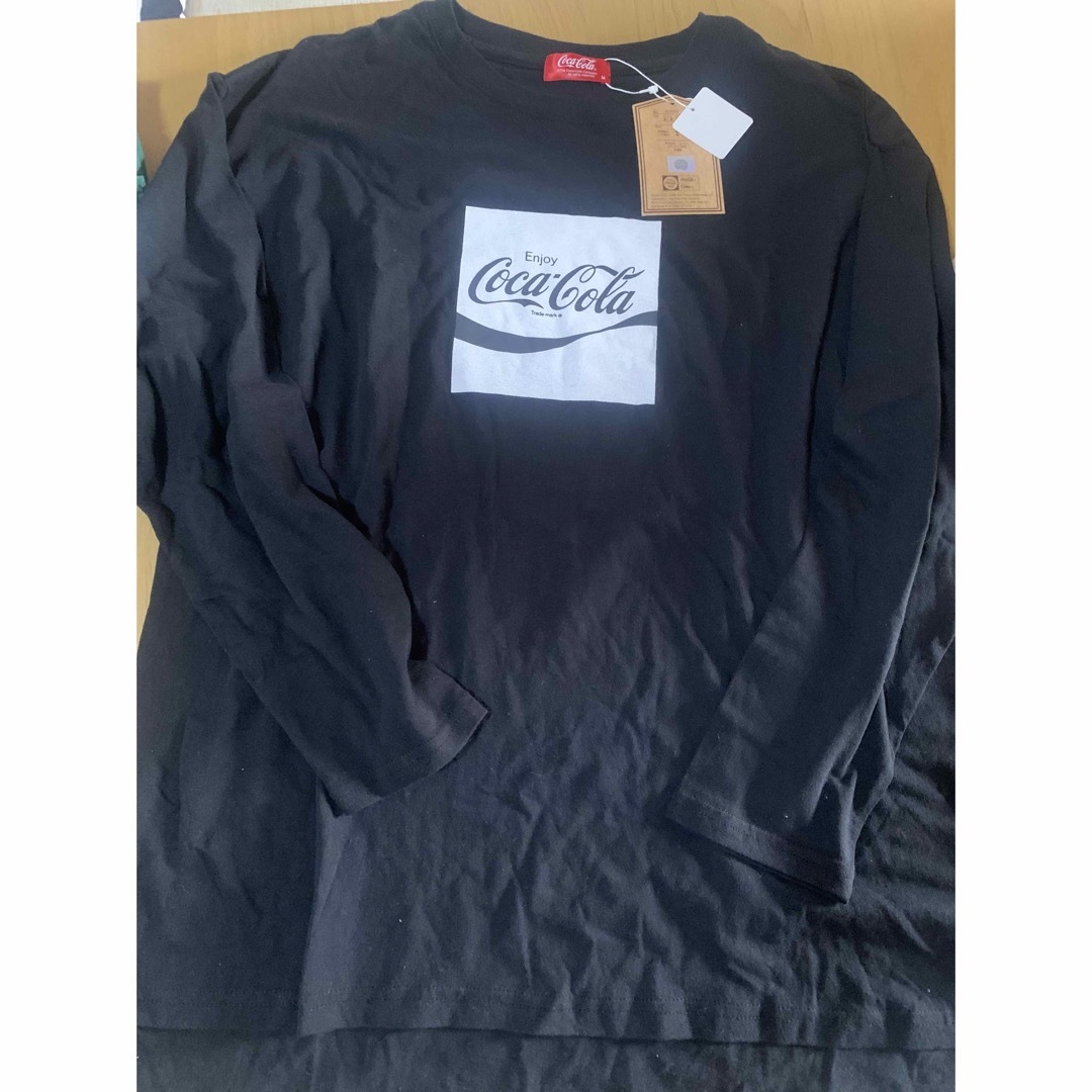 コカ・コーラ(コカコーラ)の🟤コカコーラMロンT黒新品 レディースのトップス(Tシャツ(長袖/七分))の商品写真