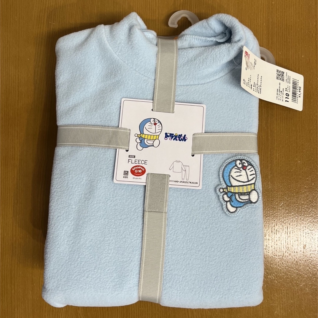 UNIQLO(ユニクロ)の【新品】ユニクロ ドラえもん フリース 110 キッズ/ベビー/マタニティのキッズ服男の子用(90cm~)(パジャマ)の商品写真