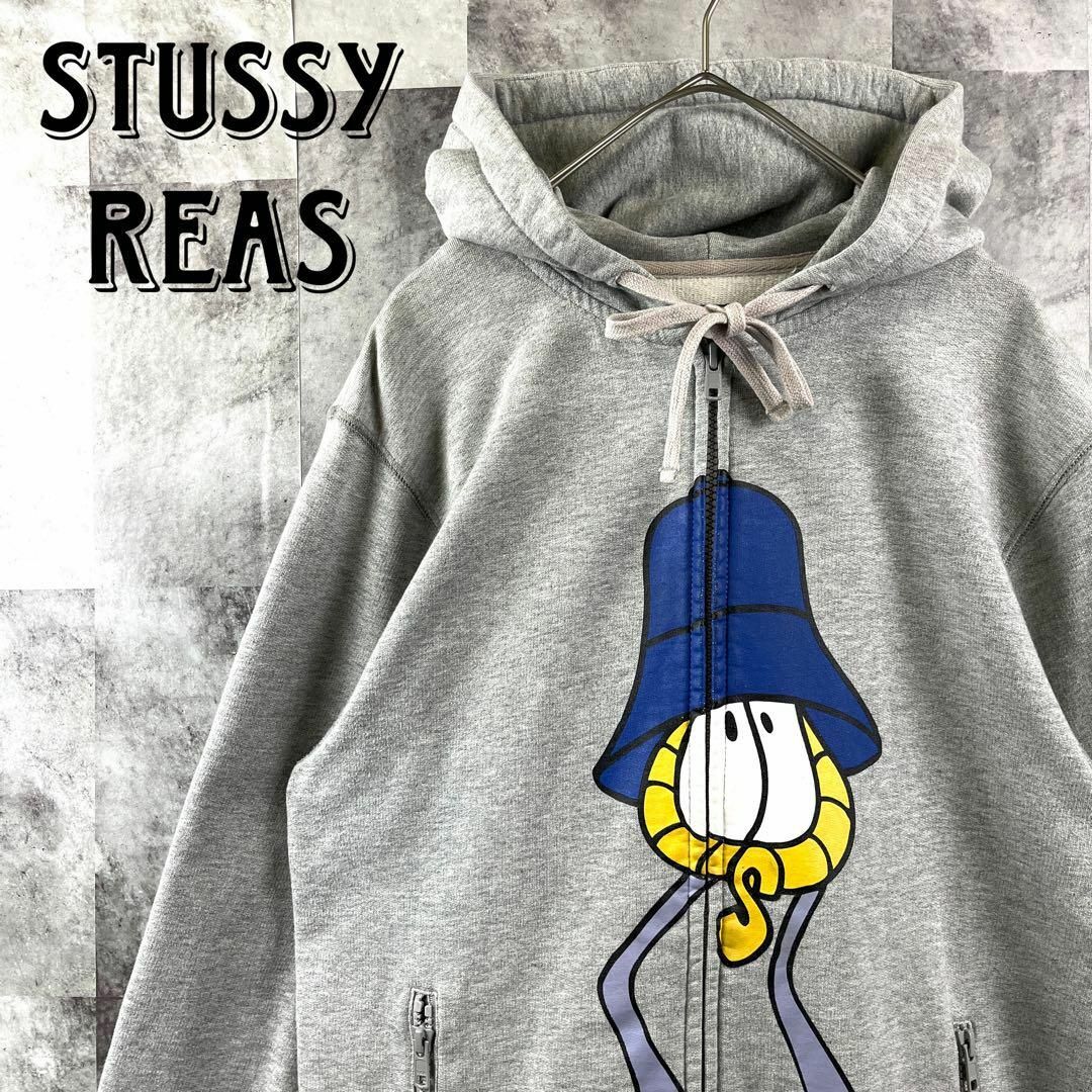 希少コラボ STUSSY×REAS ジップアップパーカー プリント&フードロゴ