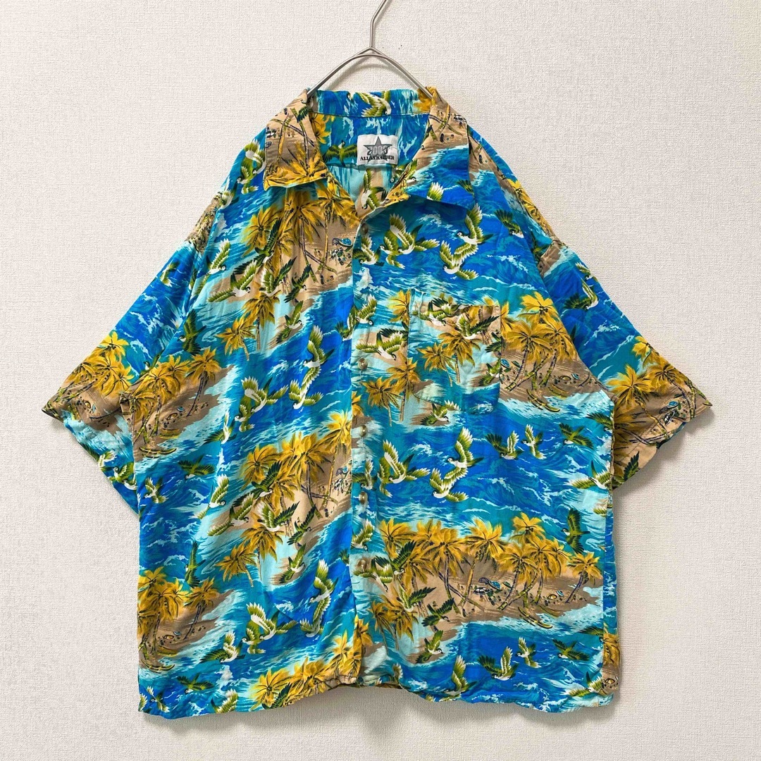 US古着　アロハシャツ　ハワイアン　半袖　総柄　風景　鳥　ヤシの木　男女兼用 メンズのトップス(シャツ)の商品写真