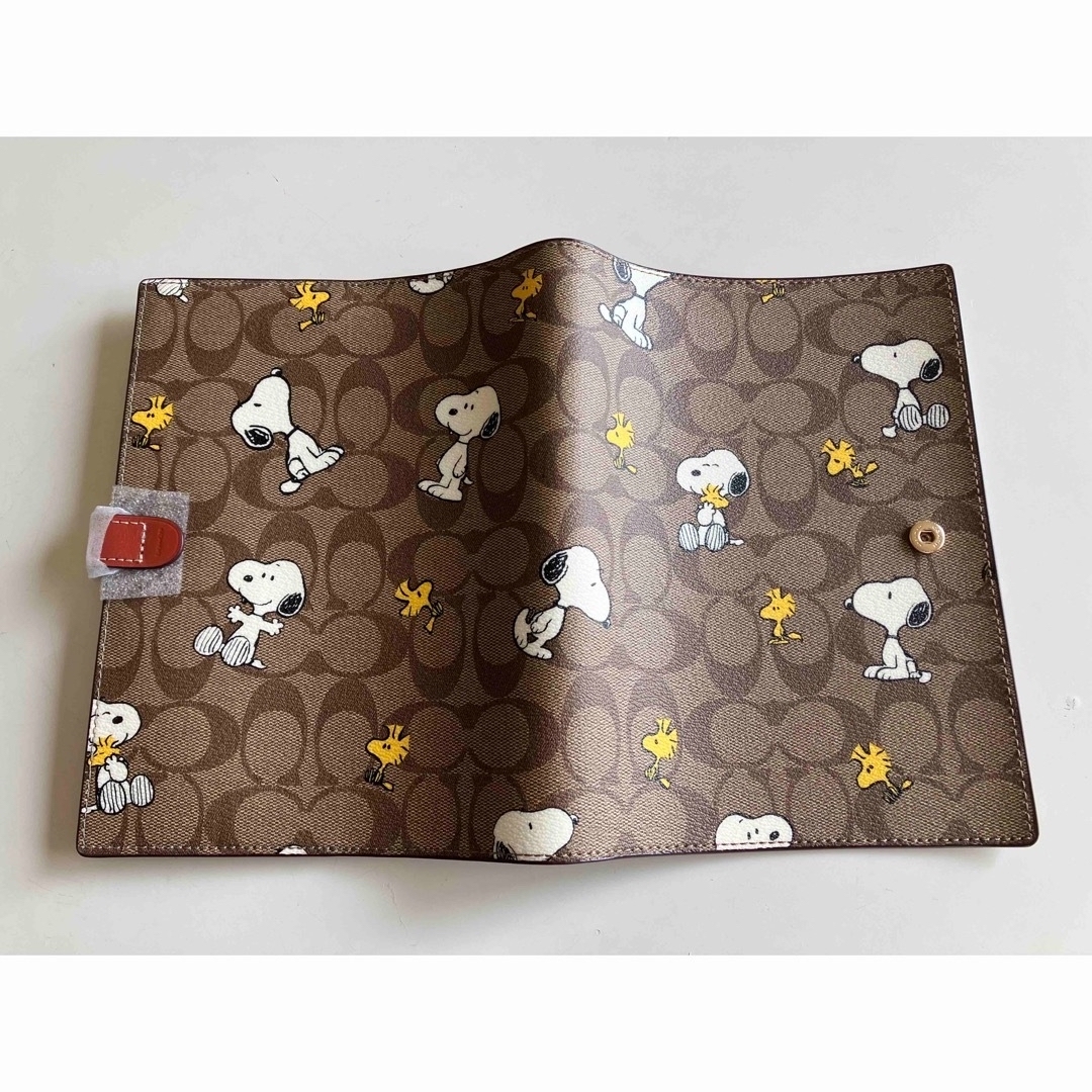 COACH(コーチ)の訳あり　北米限定激レア！【COACH×PEANUTS】CE961 ノートカバー インテリア/住まい/日用品の文房具(ノート/メモ帳/ふせん)の商品写真