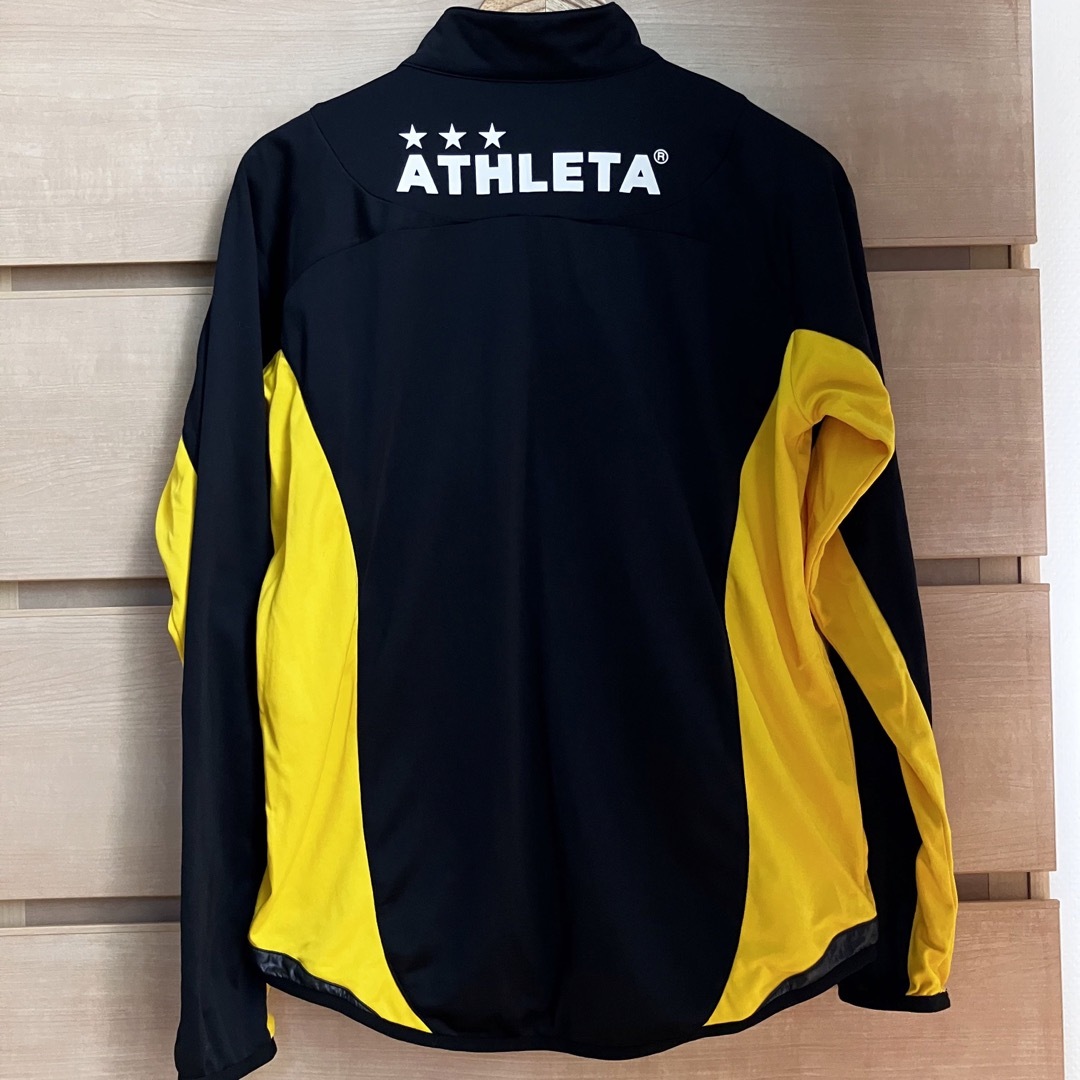 ATHLETA(アスレタ)の美品【複数割】アスレタ　ATHLETA 長袖プラクティスジャージ　黒黄色　M スポーツ/アウトドアのサッカー/フットサル(ウェア)の商品写真