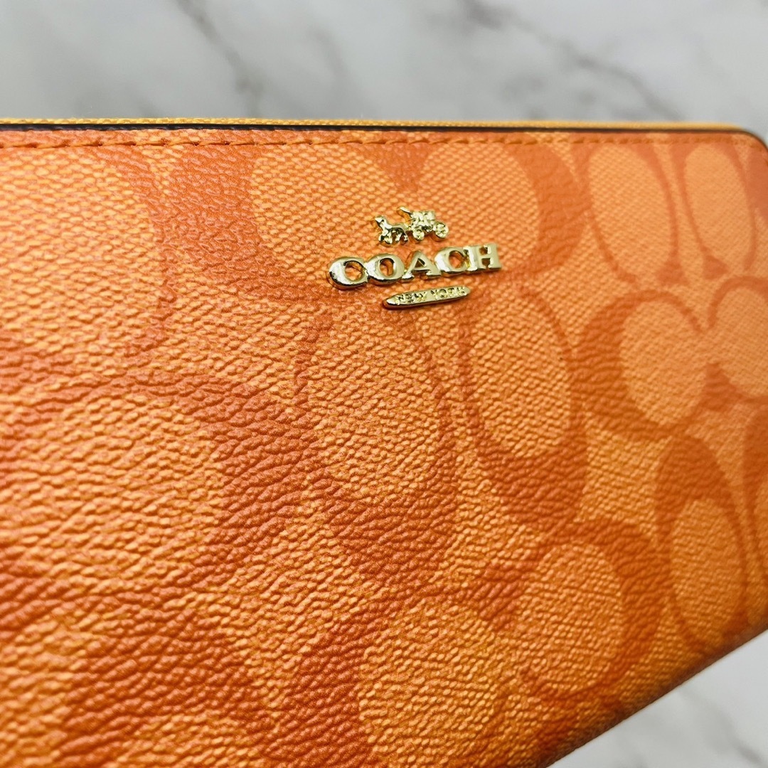 COACH(コーチ)のCOACH 長財布 オレンジ シグネチャー  ストラップ付 レディースのファッション小物(財布)の商品写真