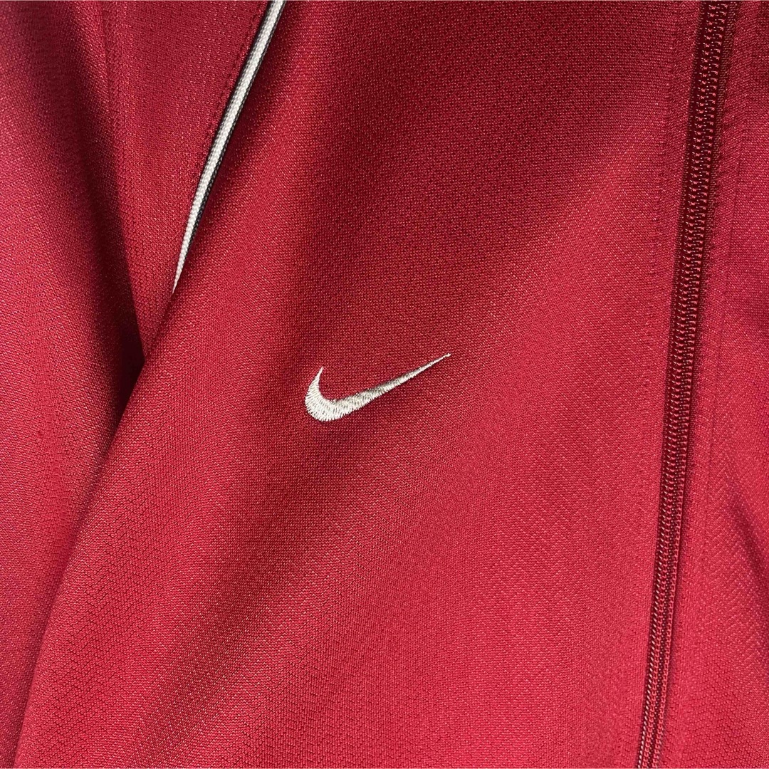 NIKE(ナイキ)の[古着]NIKE　トラックジャケット　スウッシュ刺繍　アームライン　ラグラン　赤 メンズのトップス(ジャージ)の商品写真