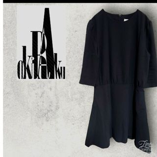 オキラク(OKIRAKU)の美品　Okiraku　Aラインワンピース　Ｆ　黒　ミニ　春夏コーデ　ビックロゴ(ひざ丈ワンピース)