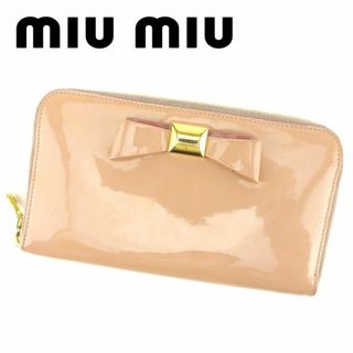 ミュウミュウ(miumiu)のミュウミュウ ラウンドファスナー ピンク エナメルレザー リボンモチーフ(財布)