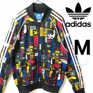 オリジナルス(Originals（adidas）)のアディダス ネームロゴ 総柄 スーパースター トラックトップ ジャージ 男性M(ジャージ)