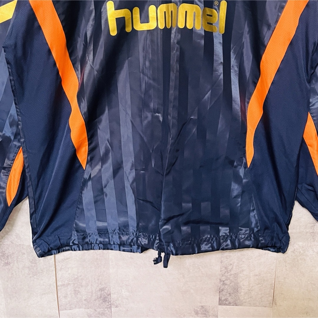 hummel(ヒュンメル)のヒュンメルピステウインドブレーカー　プルオーバー　M ネイビー×オレンジ×金ロゴ メンズのジャケット/アウター(ナイロンジャケット)の商品写真