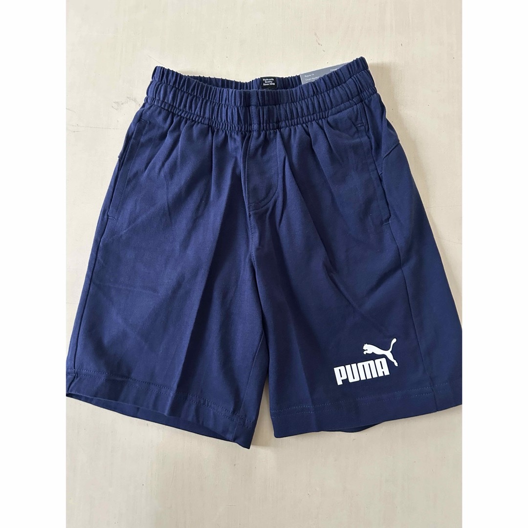 PUMA(プーマ)の新品タグ付き　130㎝ PUMAプーマ上下セットアップ　レッド×ネイビー キッズ/ベビー/マタニティのキッズ服男の子用(90cm~)(Tシャツ/カットソー)の商品写真