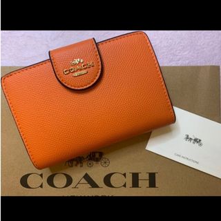 コーチ(COACH)の新品　COACH　二つ折り財布　小銭入れ有　オレンジ　レザー　ワンポイント(財布)