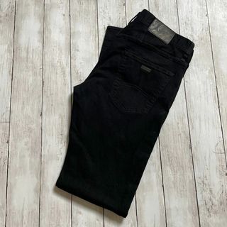 アルマーニエクスチェンジ(ARMANI EXCHANGE)のアルマーニ　ストレッチデニム　Ｗ30Ｌ30　黒ブラックやや薄手　メンズ　古着(デニム/ジーンズ)