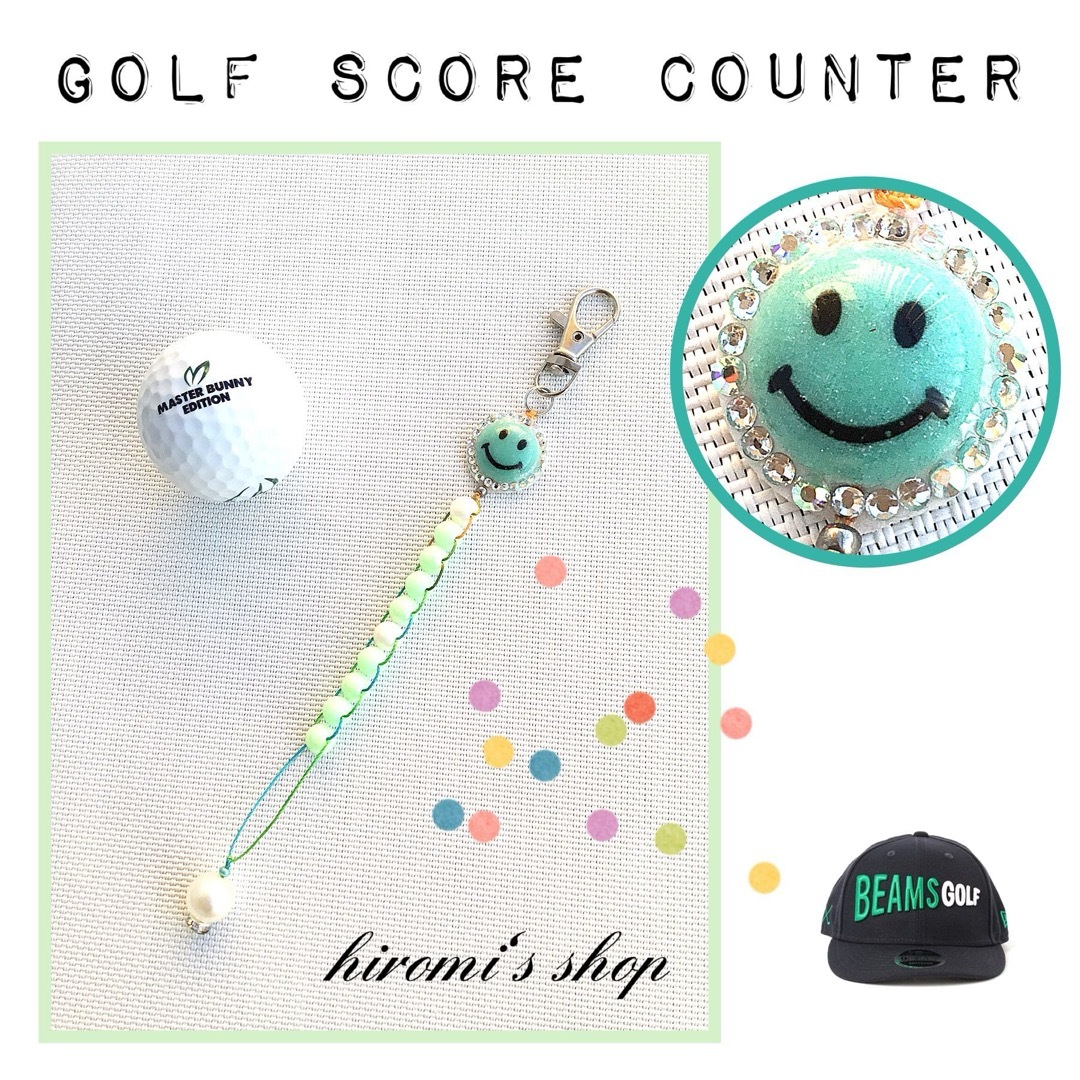 DESCENTE(デサント)のゴルフ　スコアカウンター　キラキラニコちゃん　スカート ボールケース キャップに スポーツ/アウトドアのゴルフ(ウエア)の商品写真