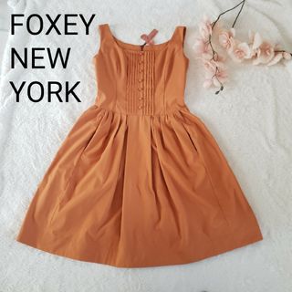 フォクシーニューヨーク(FOXEY NEW YORK)のFOXEY NEW YORKプリーツリボン付きフレアーワンピース38サイズ(ひざ丈ワンピース)