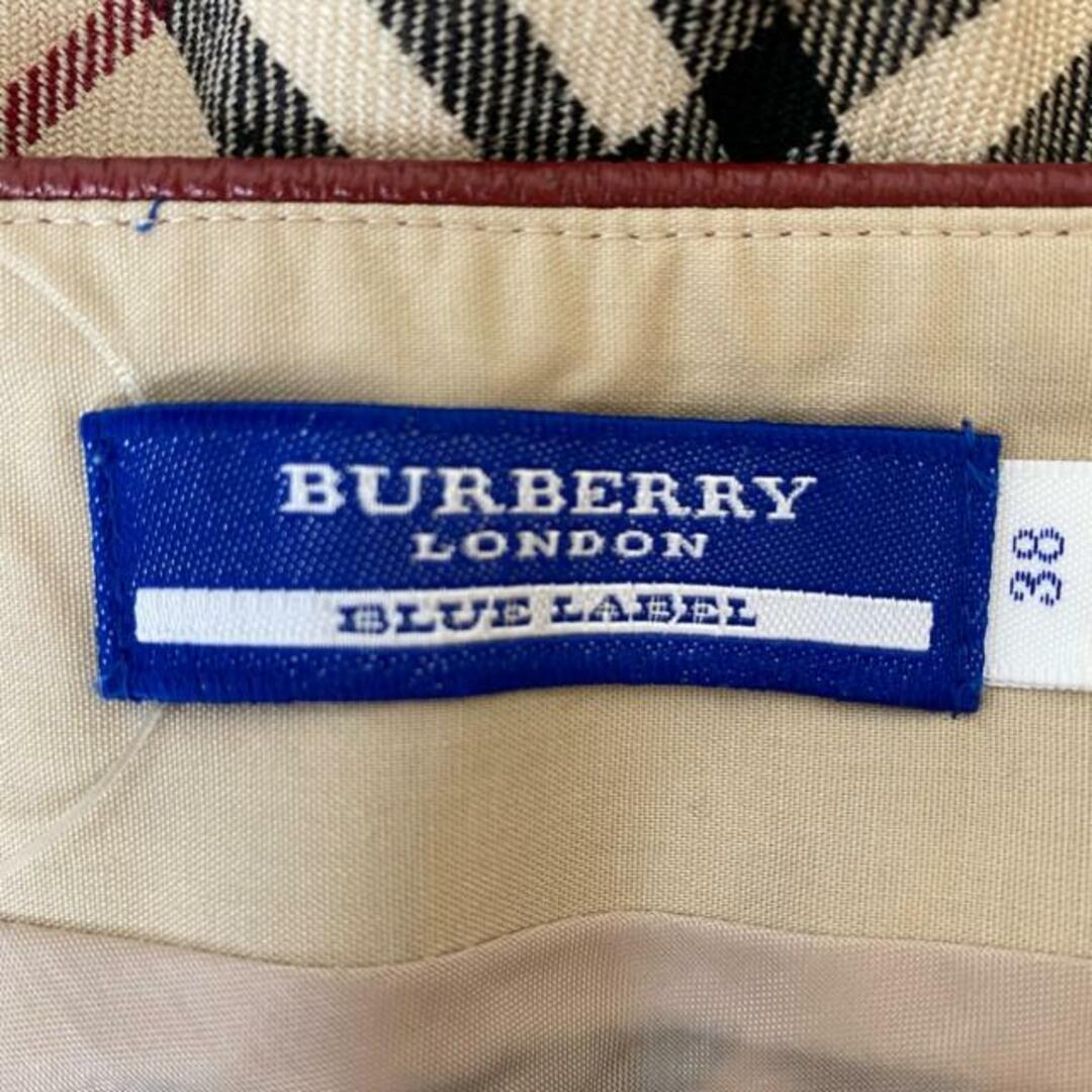 BURBERRY BLUE LABEL(バーバリーブルーレーベル)のBurberry Blue Label(バーバリーブルーレーベル) 巻きスカート サイズ38 M レディース - ベージュ×黒×レッド ひざ丈/チェック柄 レディースのスカート(その他)の商品写真