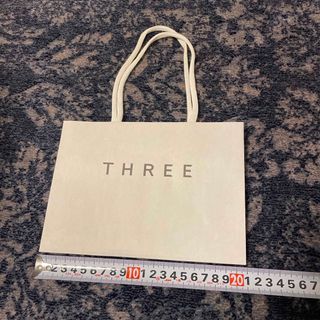 スリー(THREE)のTHREE 紙袋(ショップ袋)