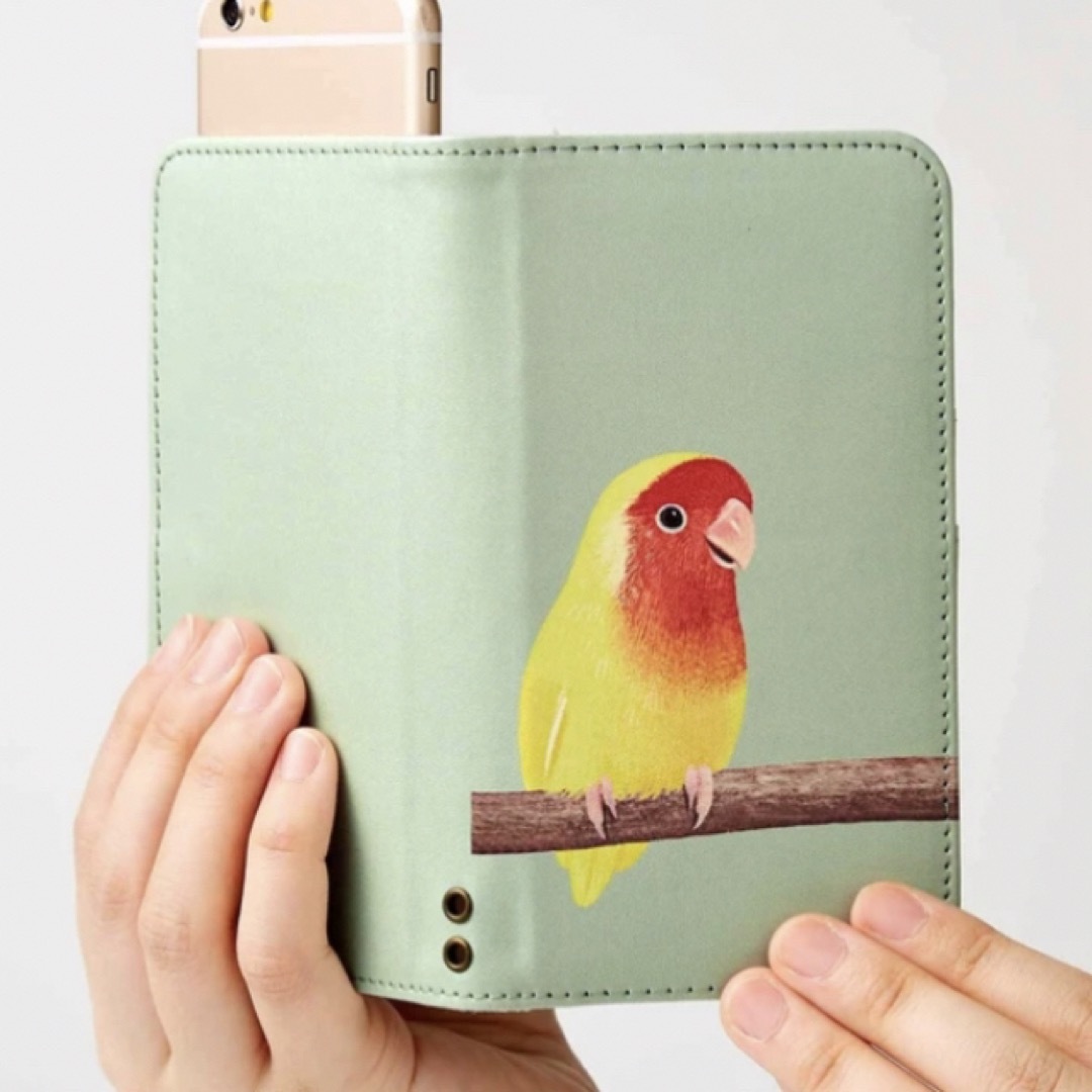 FELISSIMO(フェリシモ)の寄り添うコザクラインコのマルチスマホカバー　サイズ2 新品　フェリシモ スマホ/家電/カメラのスマホアクセサリー(iPhoneケース)の商品写真