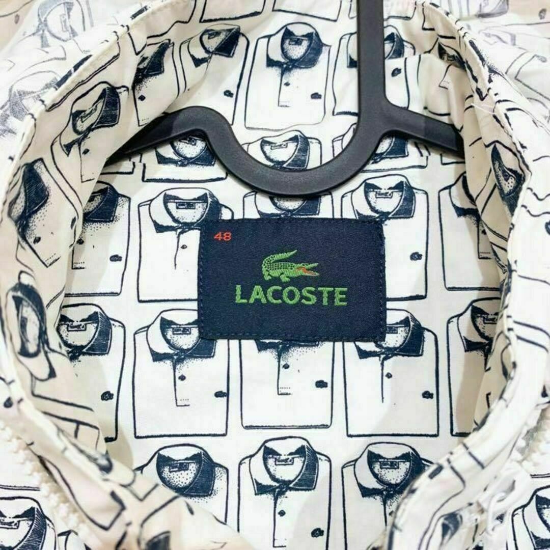 LACOSTE(ラコステ)の稀少デザイン【ラコステ】ジップアップ パーカー ポケット着脱 総柄 白×黒 メンズのジャケット/アウター(ナイロンジャケット)の商品写真