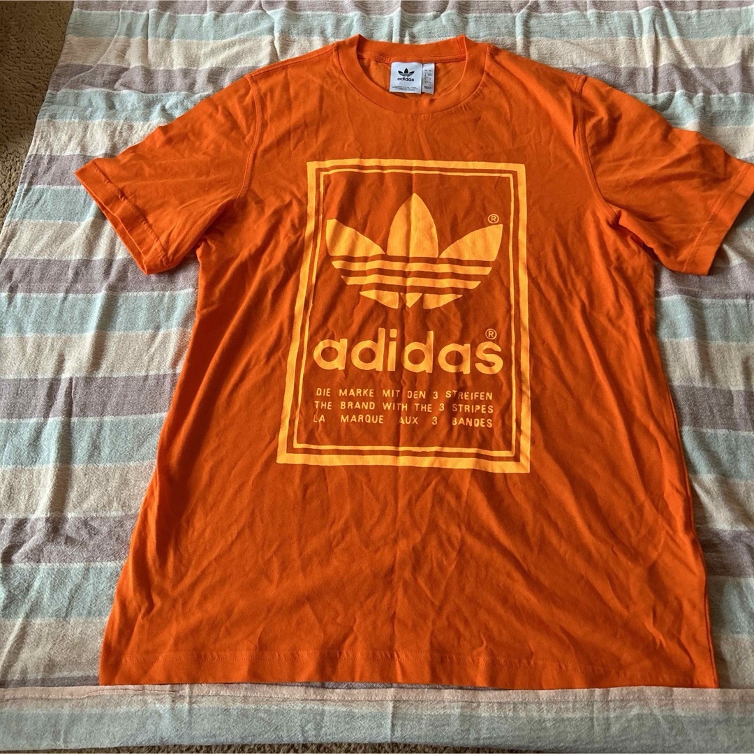 adidas(アディダス)の新品　アディダス　adidas Tシャツ　サイズO オレンジ メンズのトップス(Tシャツ/カットソー(半袖/袖なし))の商品写真