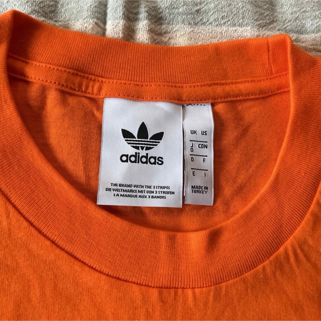 adidas(アディダス)の新品　アディダス　adidas Tシャツ　サイズO オレンジ メンズのトップス(Tシャツ/カットソー(半袖/袖なし))の商品写真